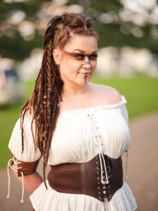 A woman in celtic makeup and clothes poses