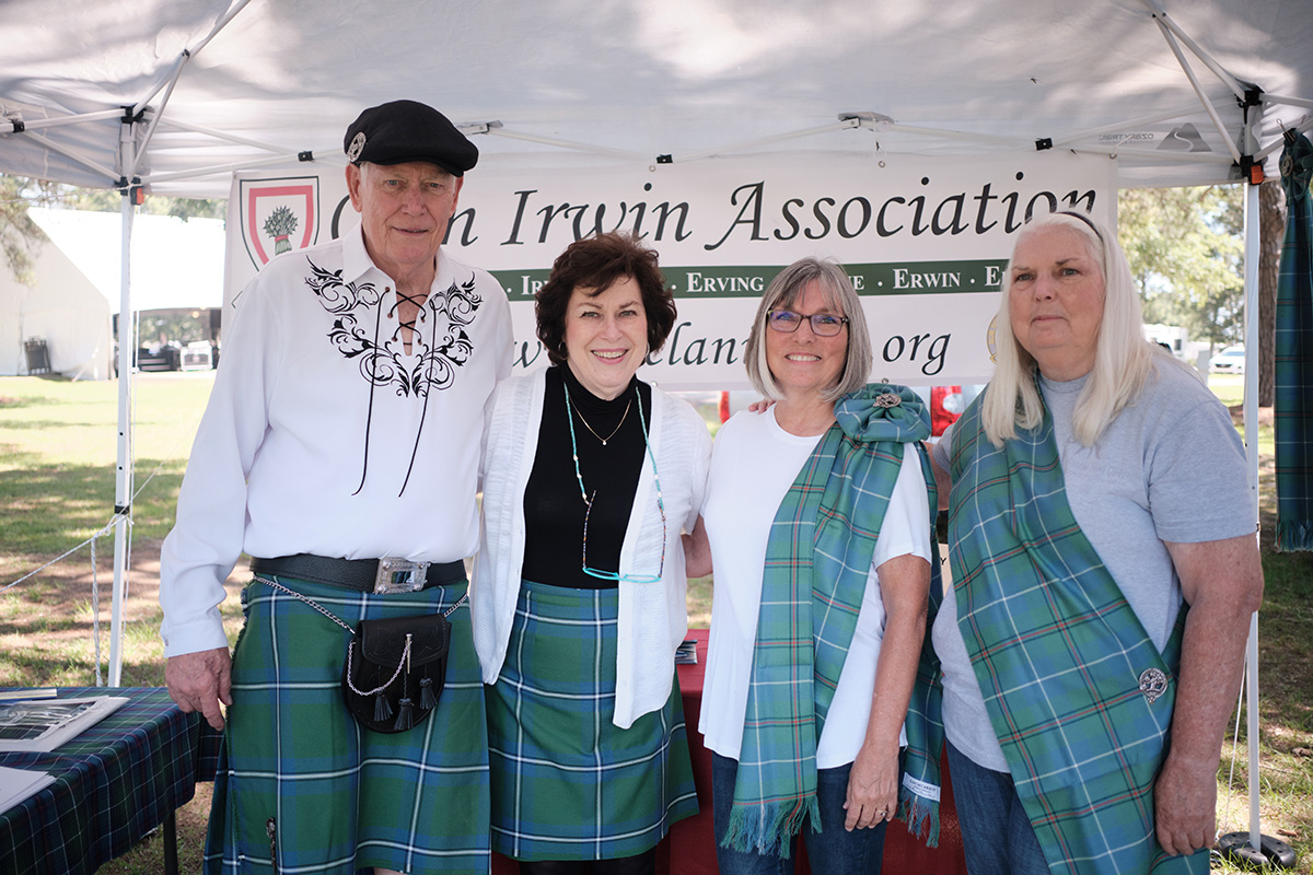 A man and four women in tartan pose for a photo