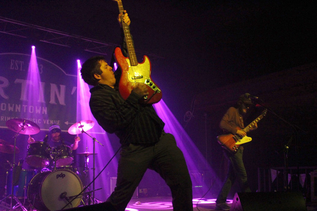 A man plays guitar on stage