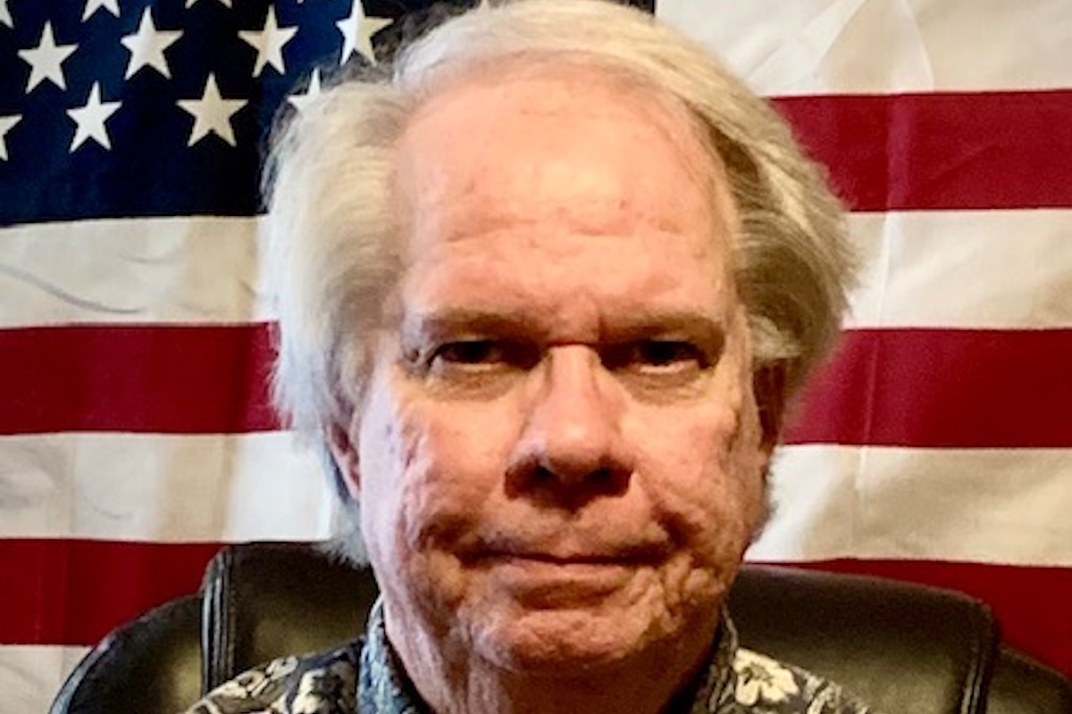 a photo of Jerry Kerner in front of an American flag