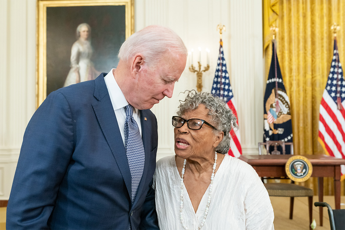 President Biden bends slightly to talk with Opal Lee in the White House