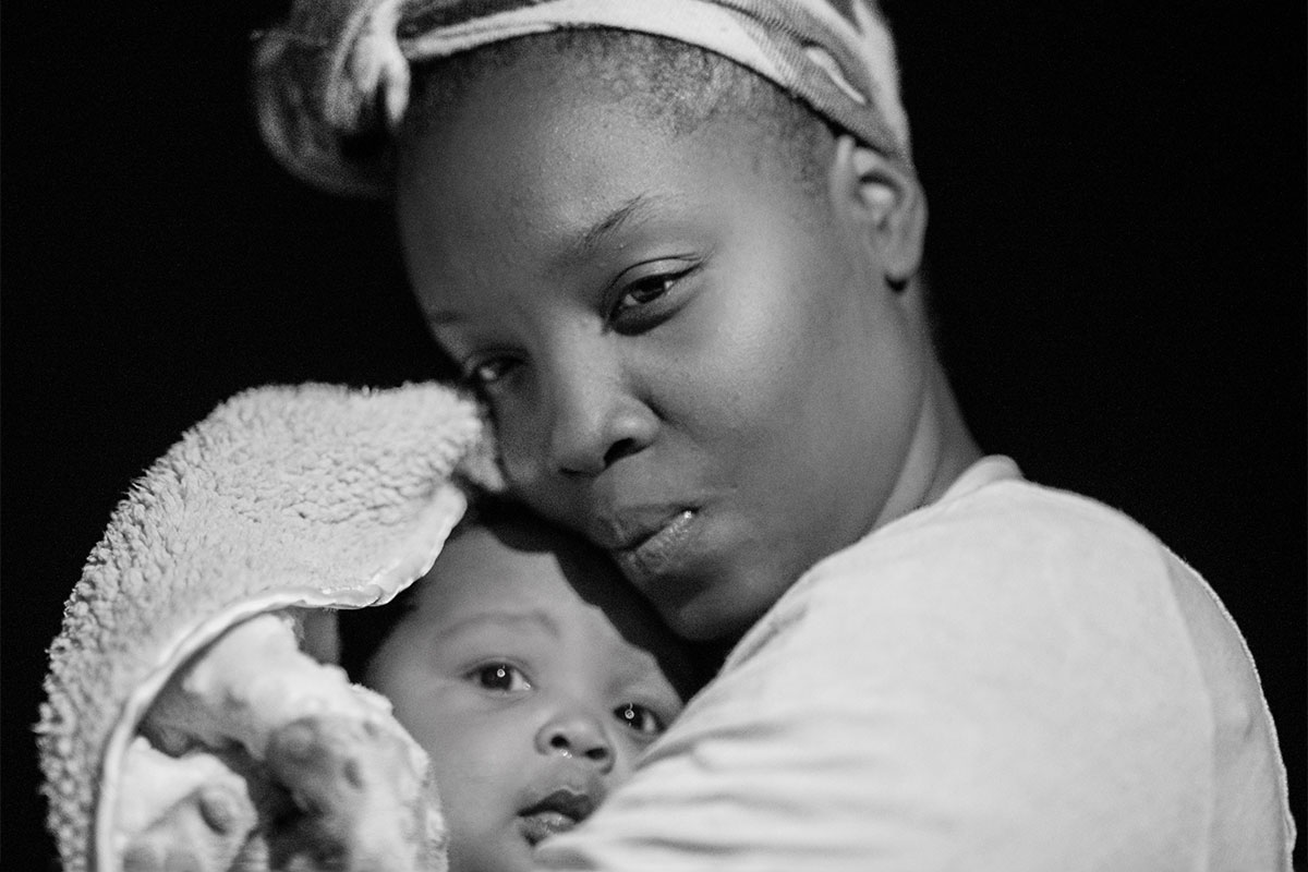 A black and white photo of a mother holding her baby