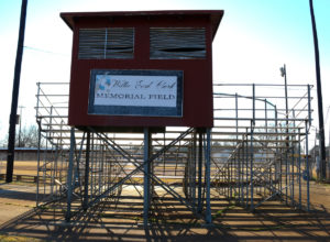 Willie Earl Clark Memorial Field sign on the back of metal stadium stands