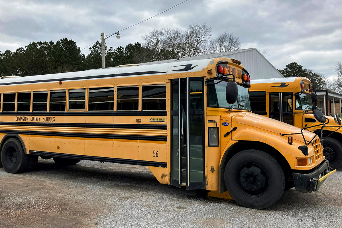 Two Covington County Schools yellow school buses park beside each other