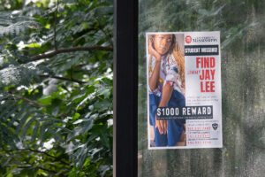 A sign with a $1000 reward to find Jay Lee
