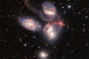 A photo showing a cluster of galaxies in the night sky