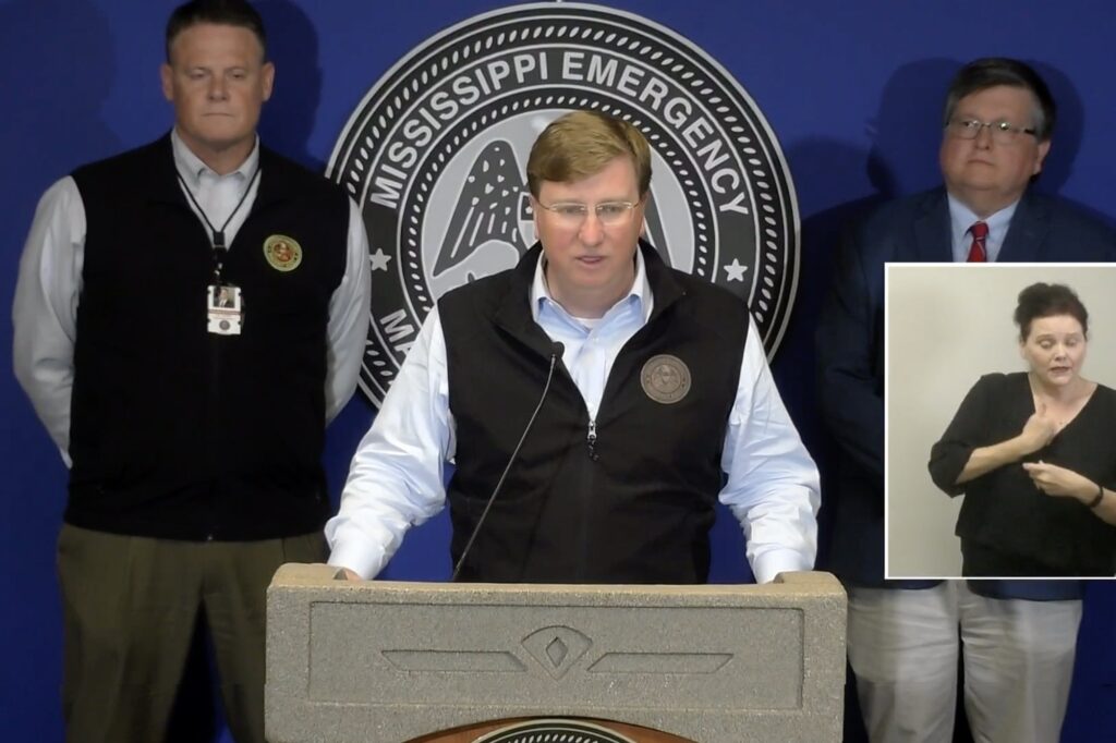 screenshot shows Gov. Tate Reeves at a podium in front of a Mississippi emergency seal