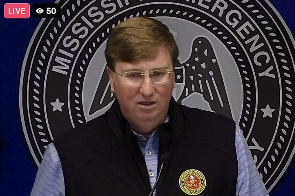 photo of Mississippi Gov. Tate Reeves in front of MS Emergency Management Agency sign
