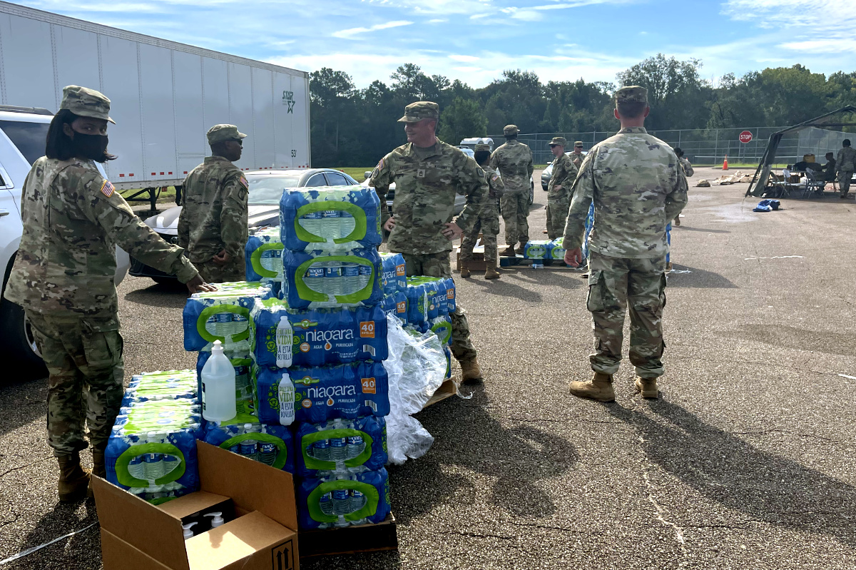 National Guard members handing out palets of water