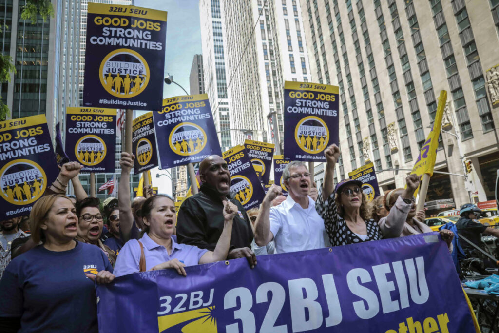 Supporters of the 32BJ SEIU commercial office cleaners union march along Sixth Avenue