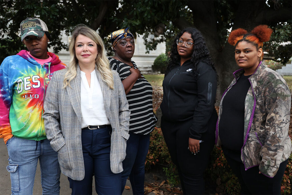 Give women stand outside the Leflore County Courthouse in Greenwood, Miss.