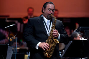 Bill Murphy playing alto saxophone on the stage