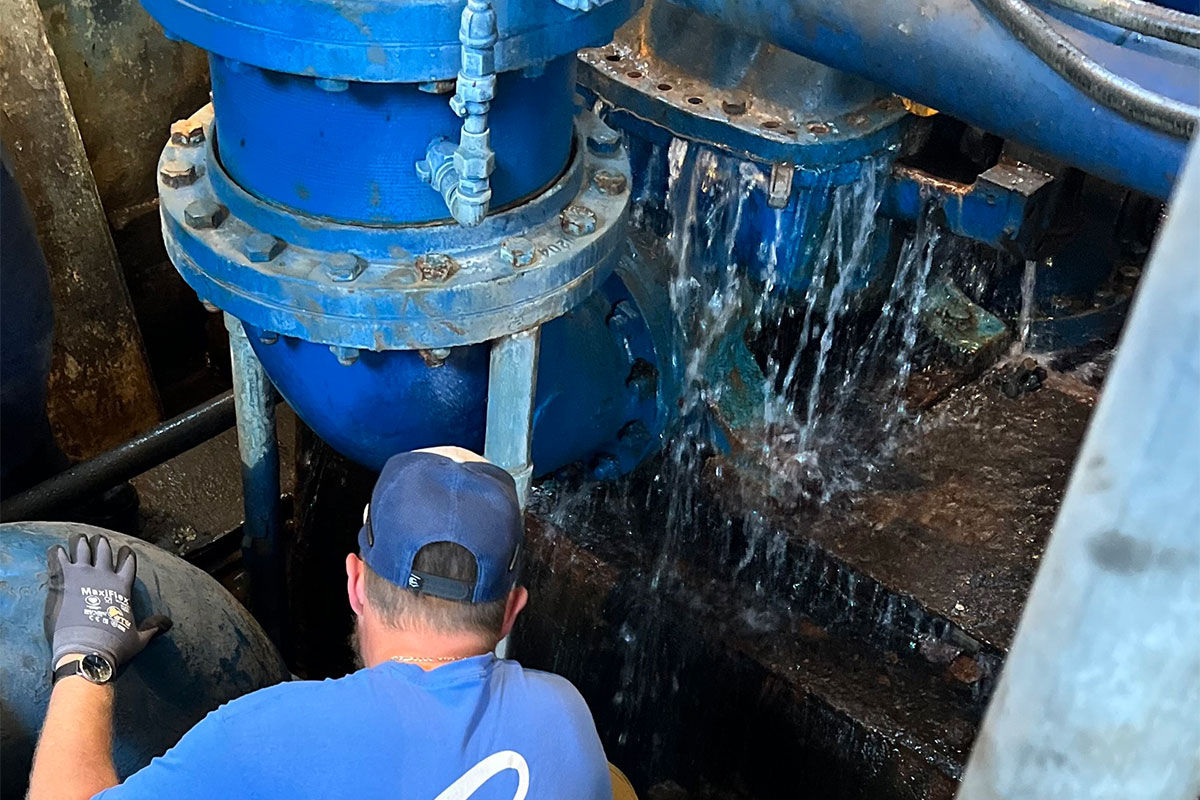 A man repairs a blue service pump at the J.H. Fewell Water Plant in Jackson