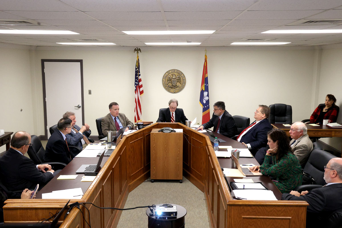 a photo of the members of the Mississippi ethics commission gathered at a meeting