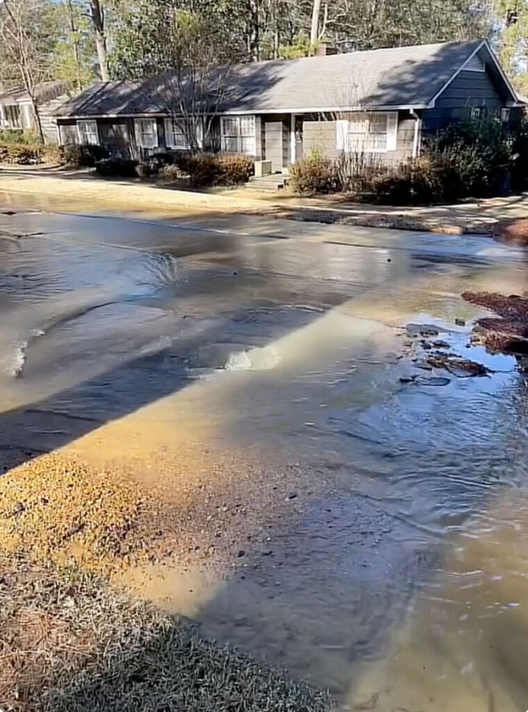 Water fills a neighborhood road due to pipe breaks