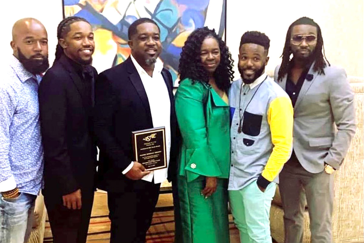 (From left) D’Andre Thigpen, Donavon Thigpen, Dorcus Curry Thigpen, Dathan Thigpen and Dorran Thigpen support Donavon (center with plaque) for winning Pastor of the Year at the Jackson Music Awards in 2019. (arts academy)