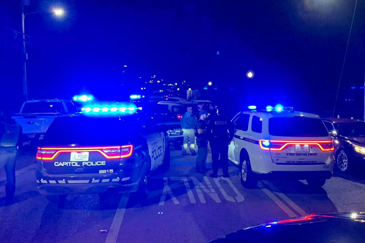 Mississippi state capitol police cars at a stop at night with blue lights on