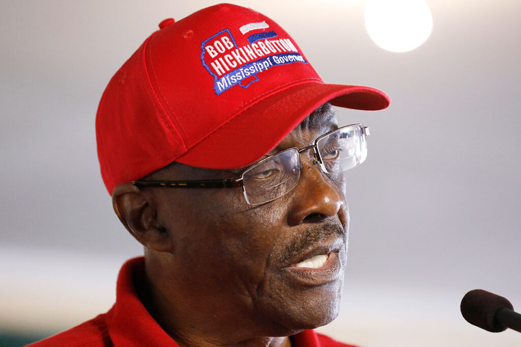 Closeup of Bob Hickingbottom, a Constitution Party candidate for governor, wearing a red campaign hat