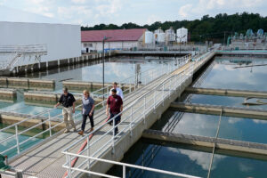 State and City officials walk past sedimentation basins at the City of Jackson's O.B. Curtis Water Treatment Facility