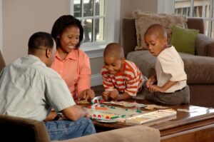 Black family playing Monopoly (tax credits)