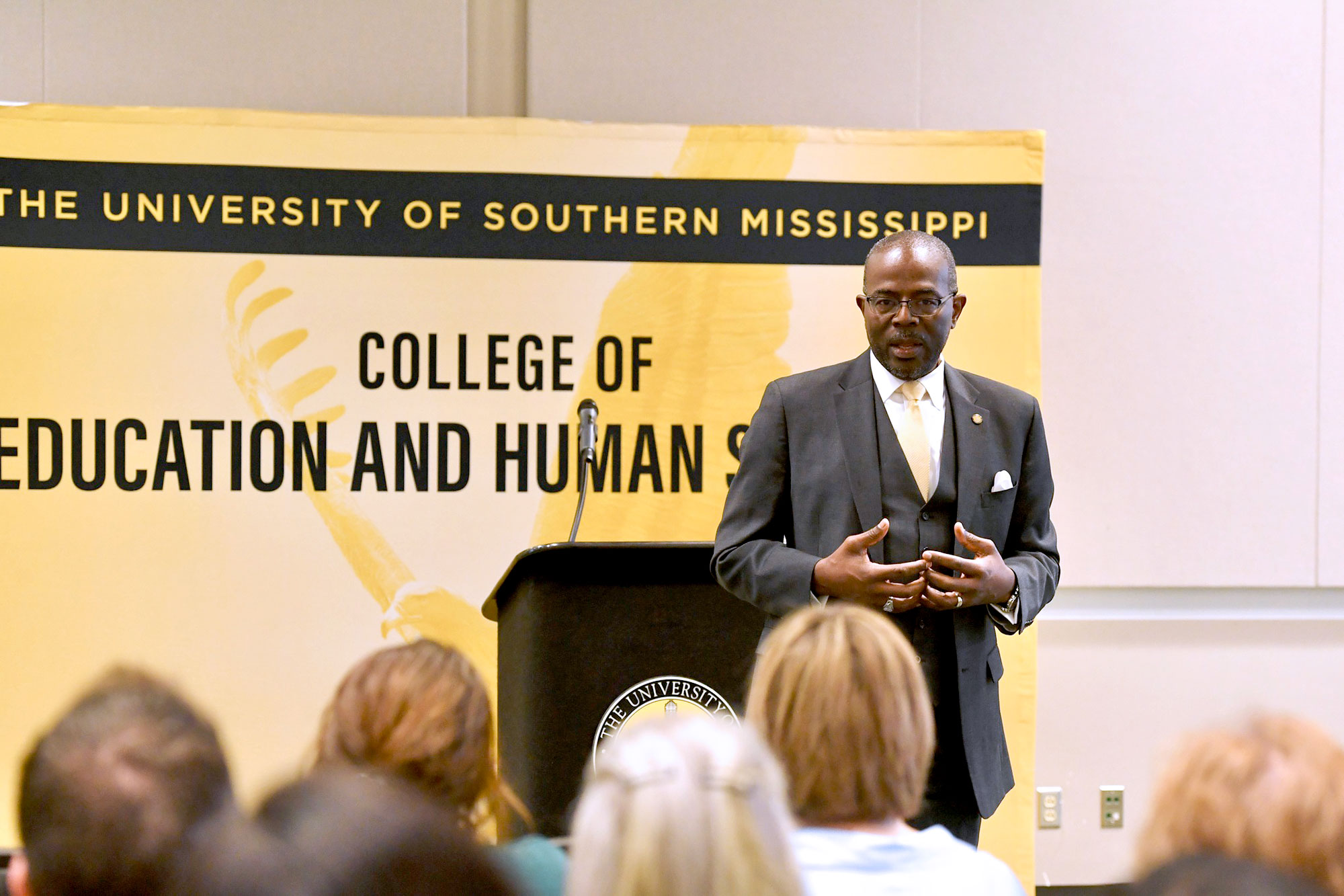 Dr. Robert Taylor speaking to a seated crowd
