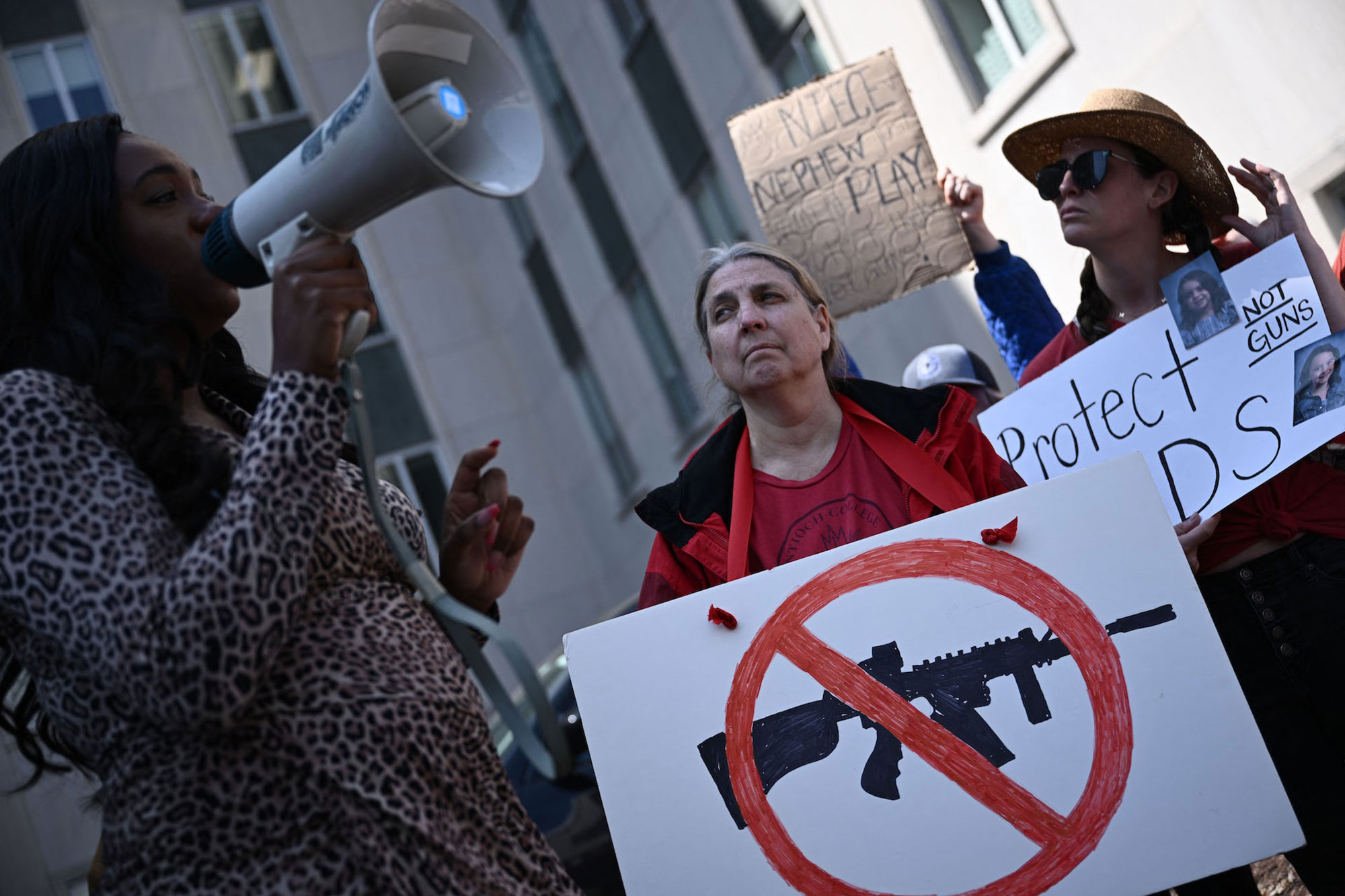 People holding signs at a gun control activists rally in Nashville, Tenn
