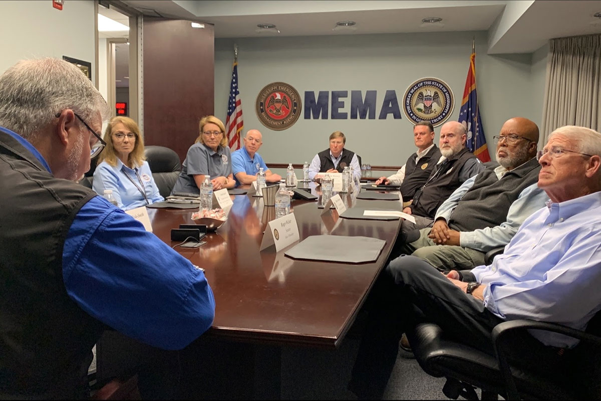 Officials in the MEMA office sit around a big conference table