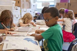 diverse group of children writing in a classroom (Jackson Public Schools)