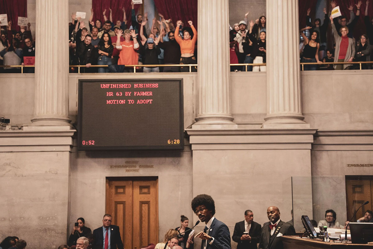 Rep. Justin J. Pearson delivers a defense to legislatures while audiences cheer silently in the second floor gallery 