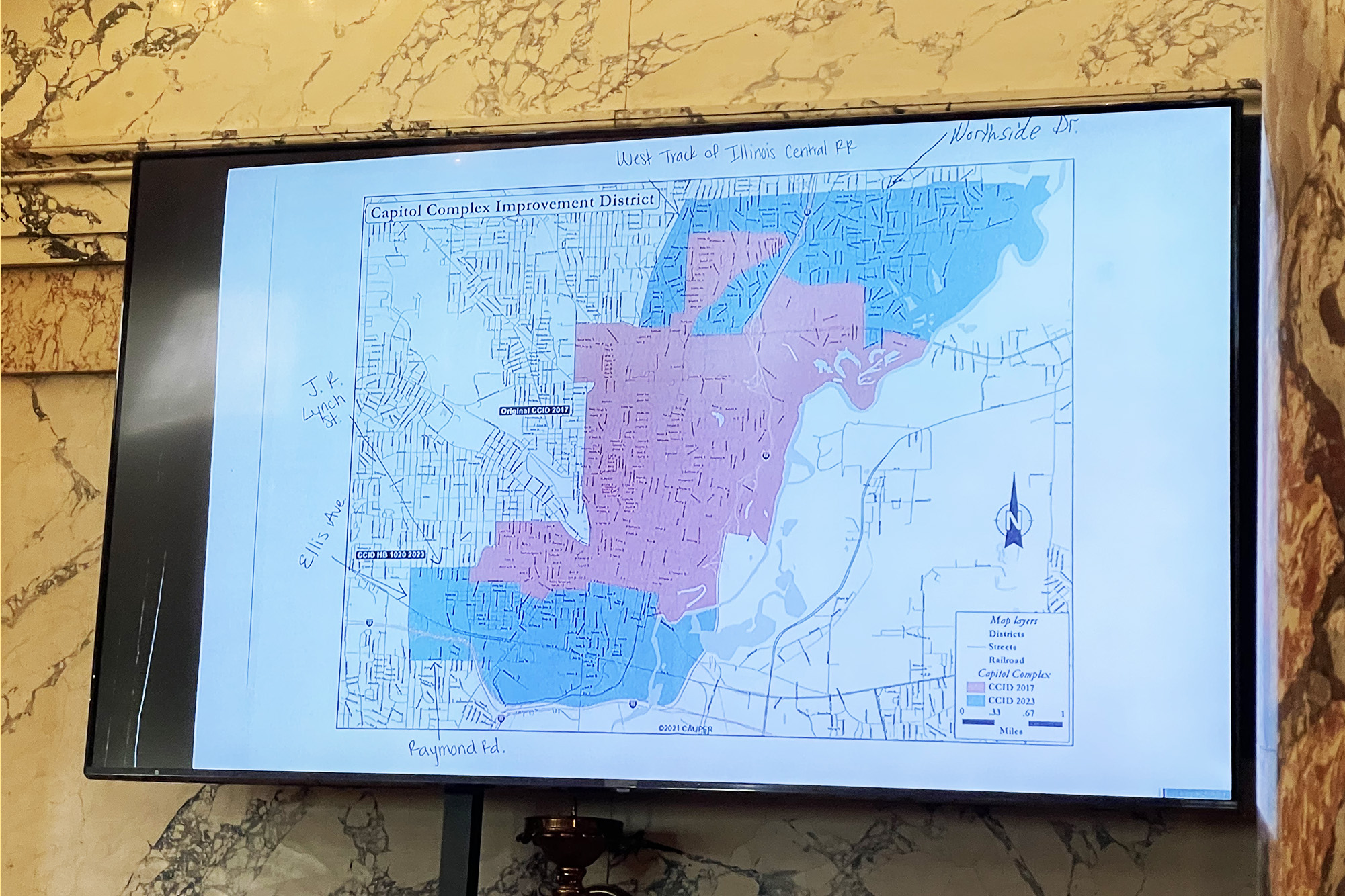 a television screen shows the map of the new CCID under HB 1020