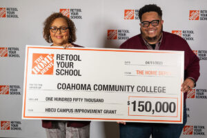 Two people from Coahoma Community College hold a check for $150,000