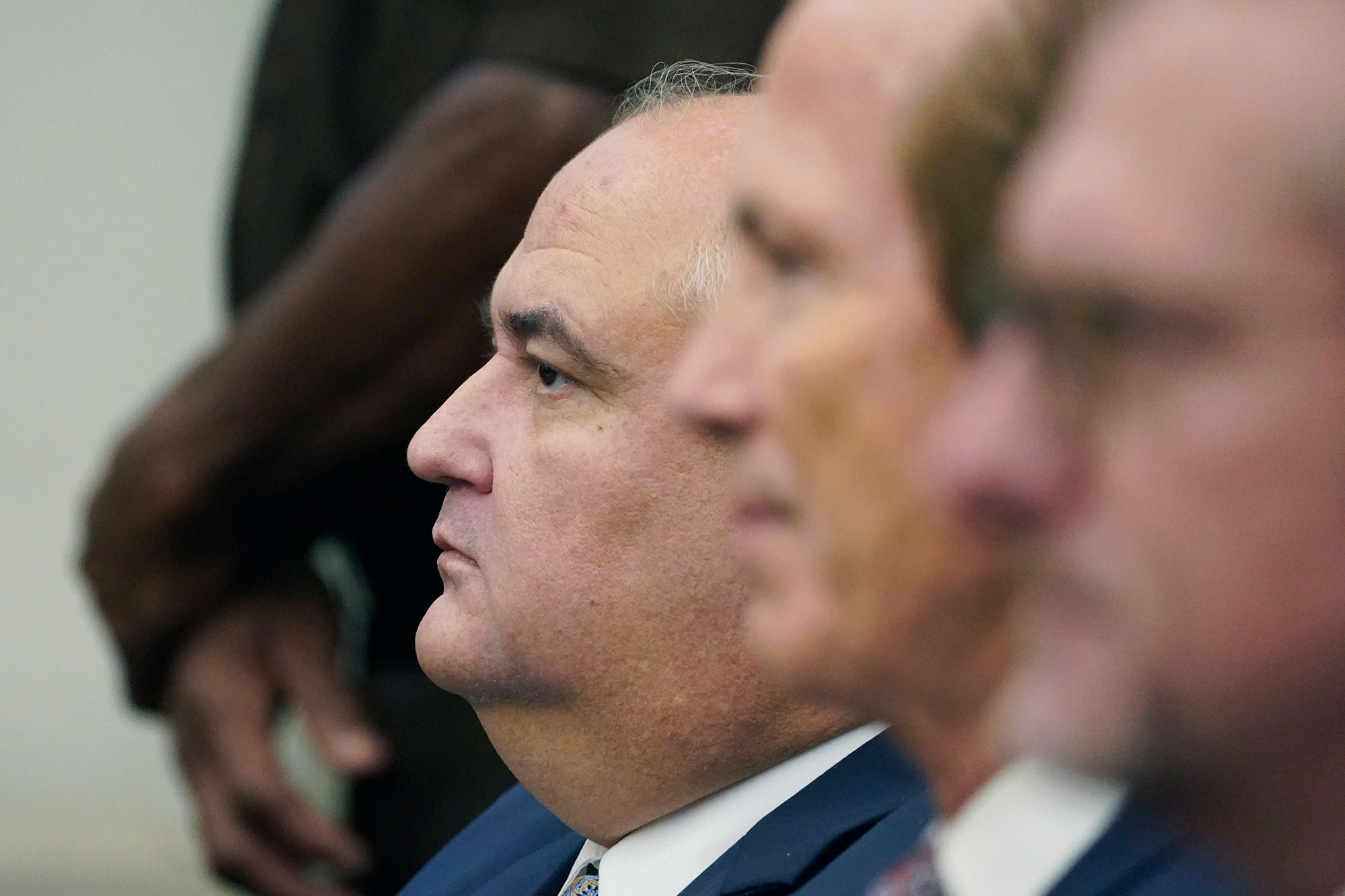 John Davis seen sitting by a row of people in court