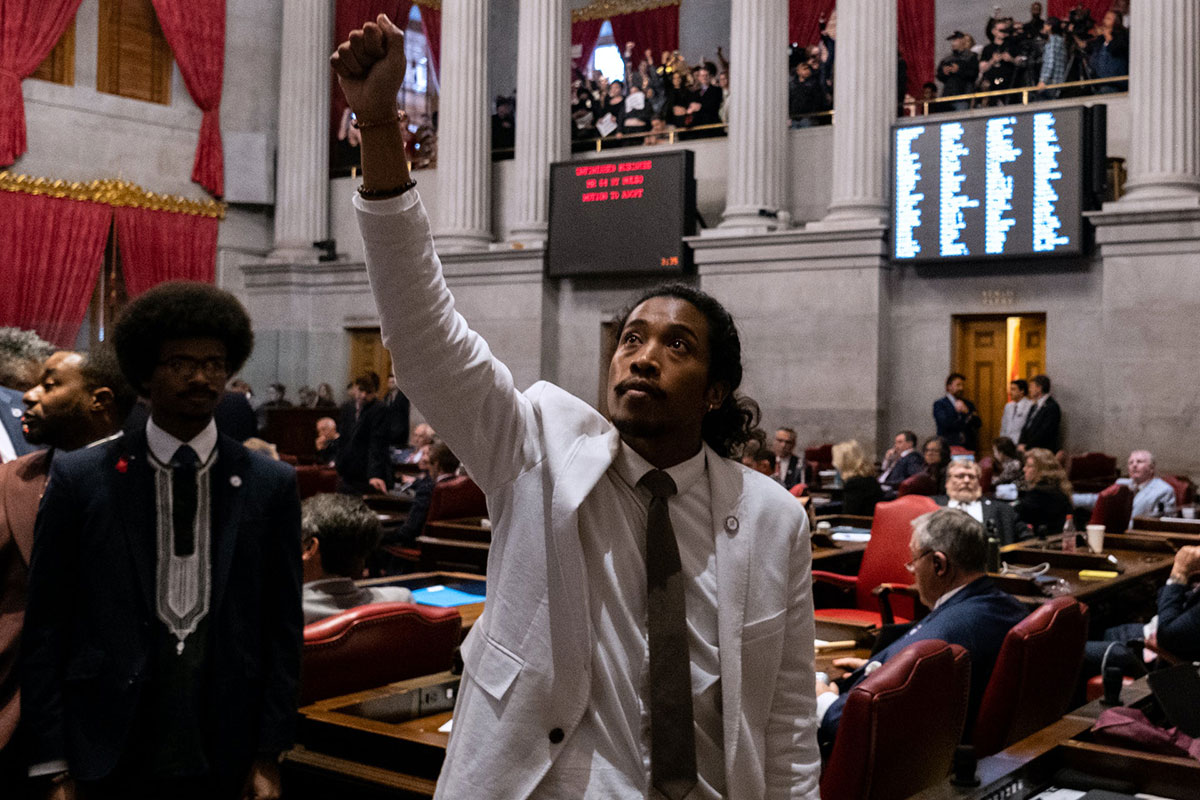 Tennessee Rep. Justin Jones raises a fist to the legislative gallery, as fellow Rep. Justin Pearson, left, looks on