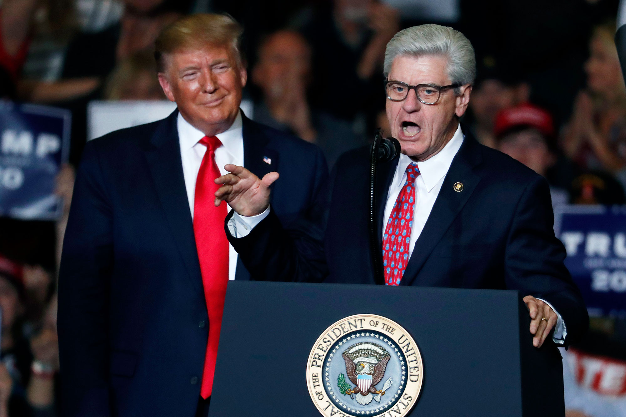 Donald Trump listens to Phil Bryant speak at a rally
