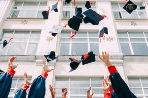 Graduates throw hats in the air