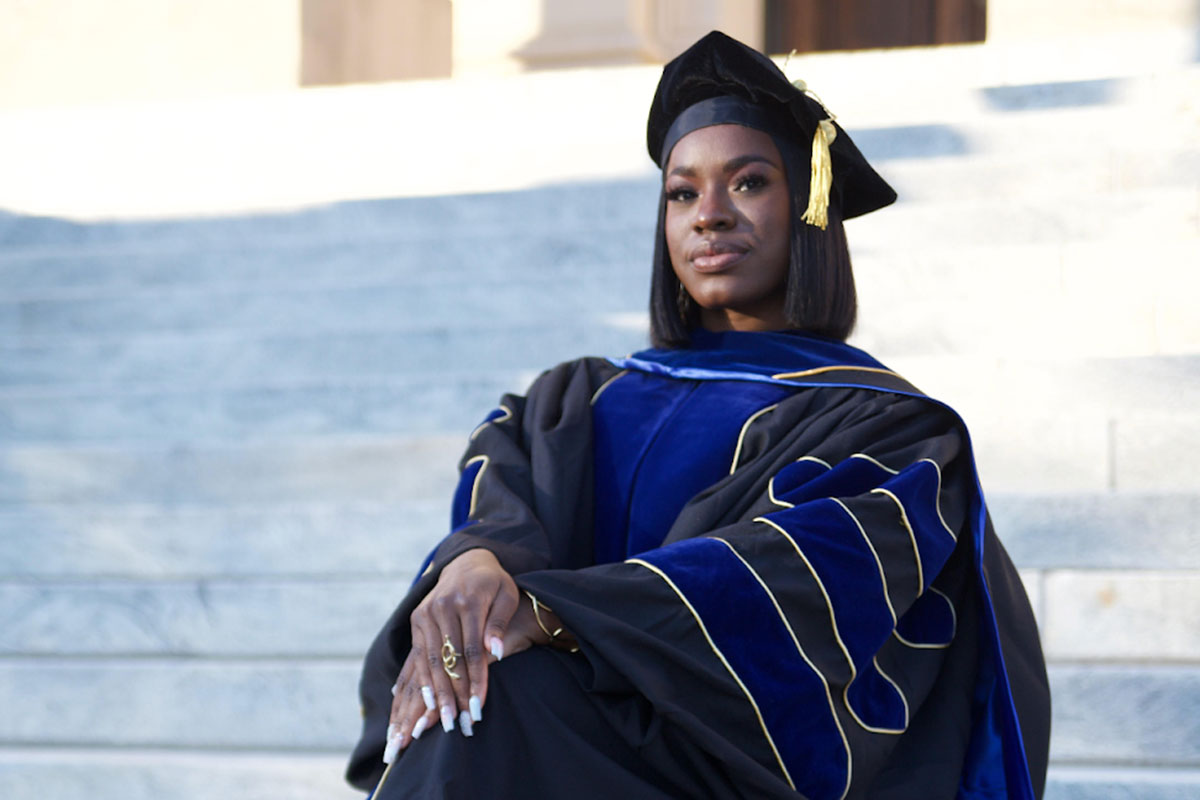 Dr. Arianna Stokes PhD cap and gown