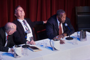 Hodding Carter, center, and former Mississippi Governor William Winter, left, listen to Charles Evers