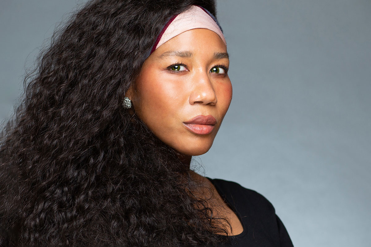 A headshot of Jill Collen Jefferson with long wavy dark hair
