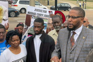 A group gathered for a Justice for Michael Corey Jenkins press conference
