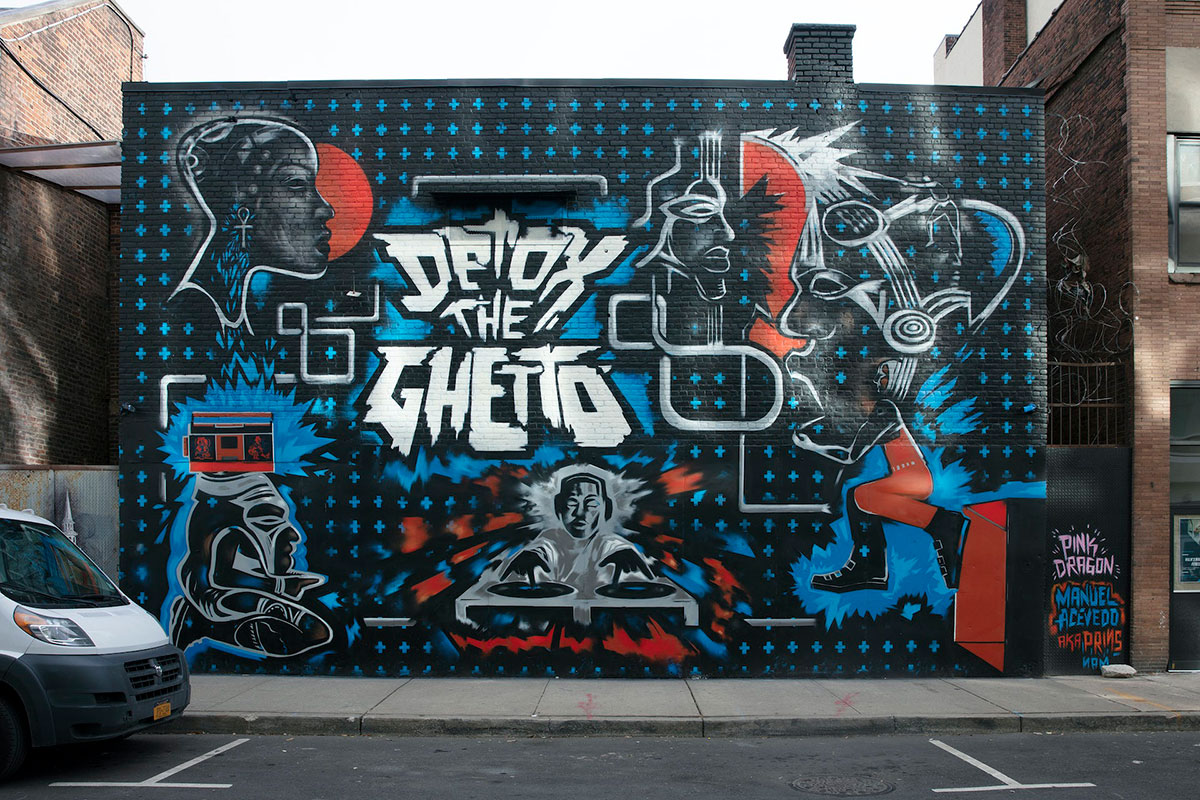 A black and blue street mural that reads Detox the Ghetto