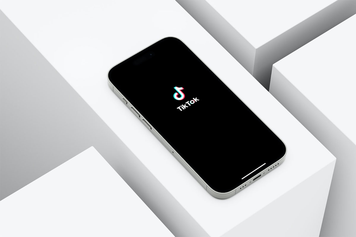 A cell phone with TikTok's logo on the screen