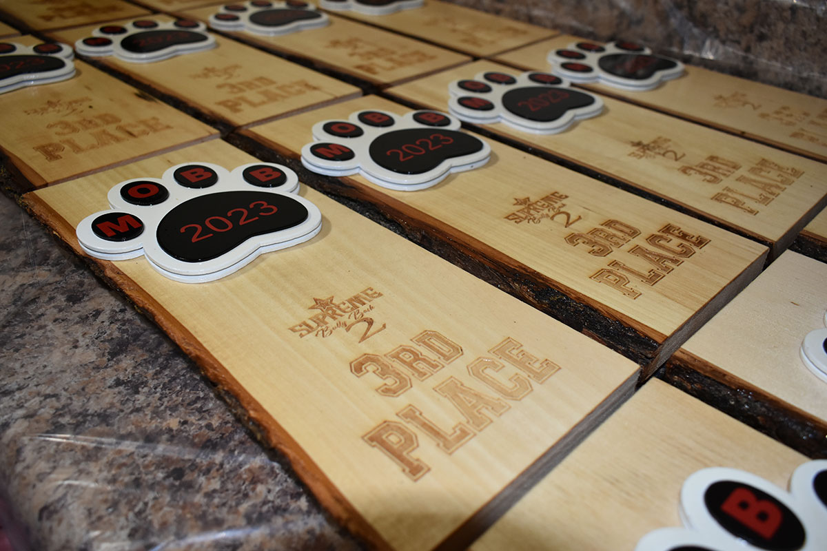 Wooden plaques with paws on top that read 3rd Place