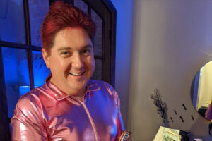 Mississippi Sen. Jeremy England, R-Vancleave wearing a pink onesie with a pink mesh skirt and dyed his hair pink to raise funds for breast cancer