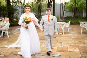Nate Schumann walks with his spouse on their wedding day