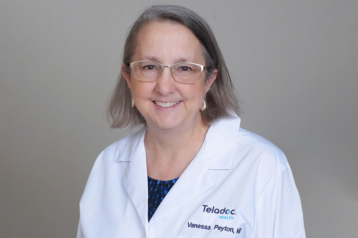 Dr. Vanessa Peyton wearing a Teladoc Health doctor's coat