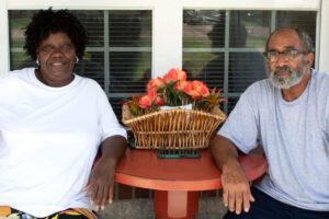 Martha and James Morris sit on a front porch