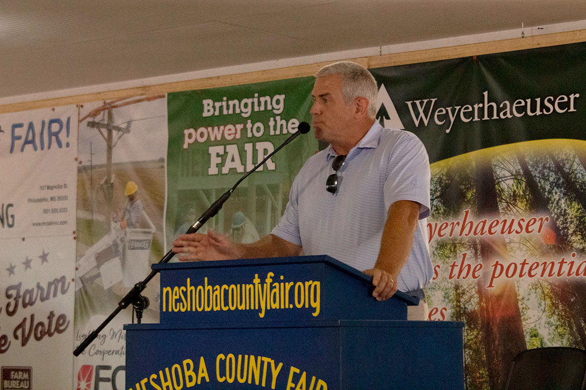 House Speaker Philip Gunn speaking at a blue podium at the Neshoba County Fair