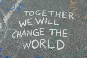 Chalk note on the ground that says Together We Will Change the World