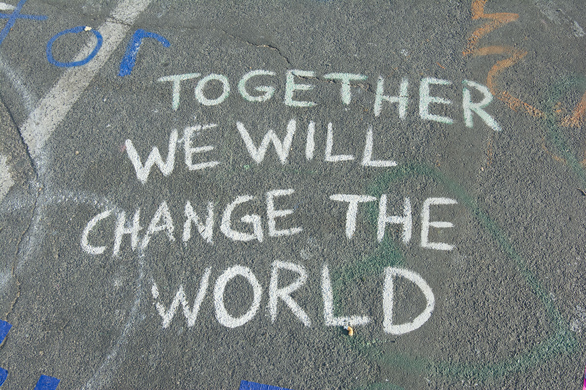 Chalk note on the ground that says Together We Will Change the World