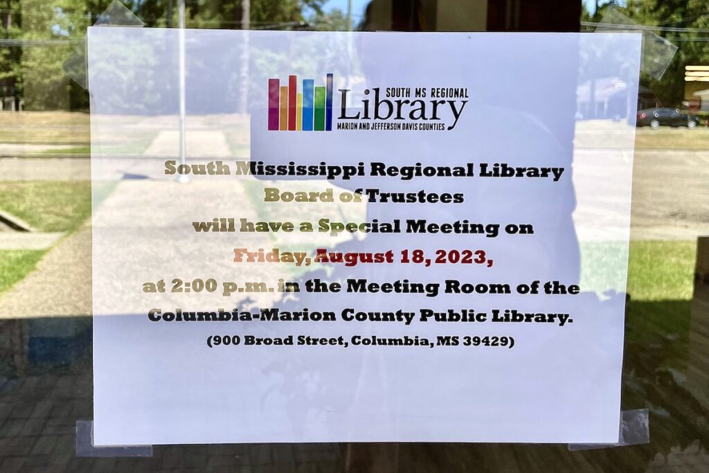 sign says: "South Mississippi Regional Library Board of Trustees will have a special meeting on Friday August 18 2023 at 2 p.m. in the Meeting Room of the Columbia-Marion County Public Library (900 Broad Street Columbia MS 39429)